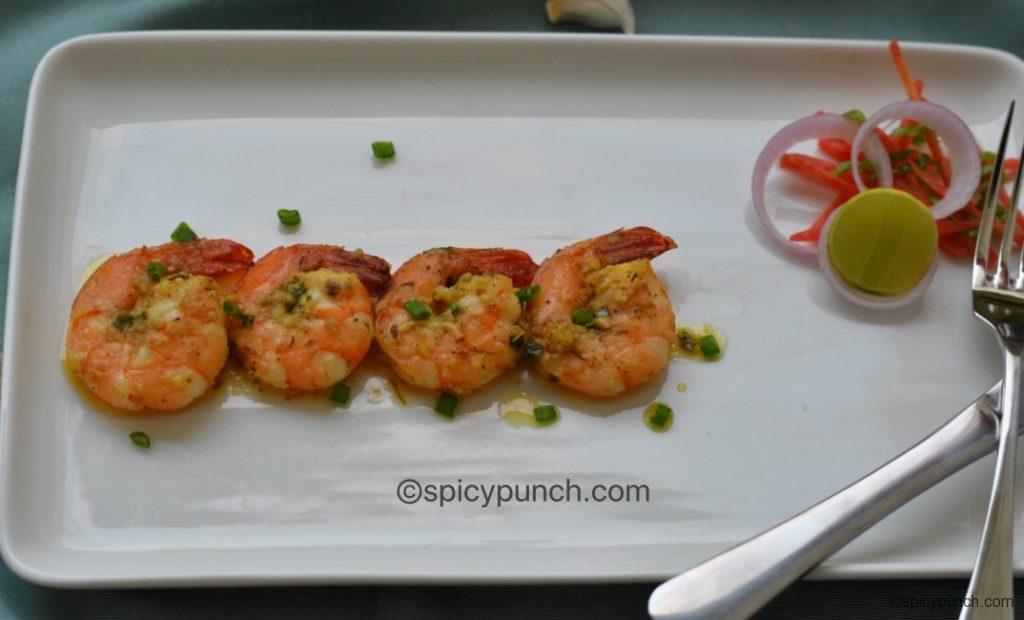 butter garlic prawns served with salad and lemon 