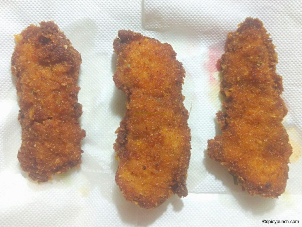 strips on the paper towel of crispy fried chicken tenders