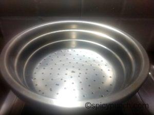 Colander pan used to steam modak