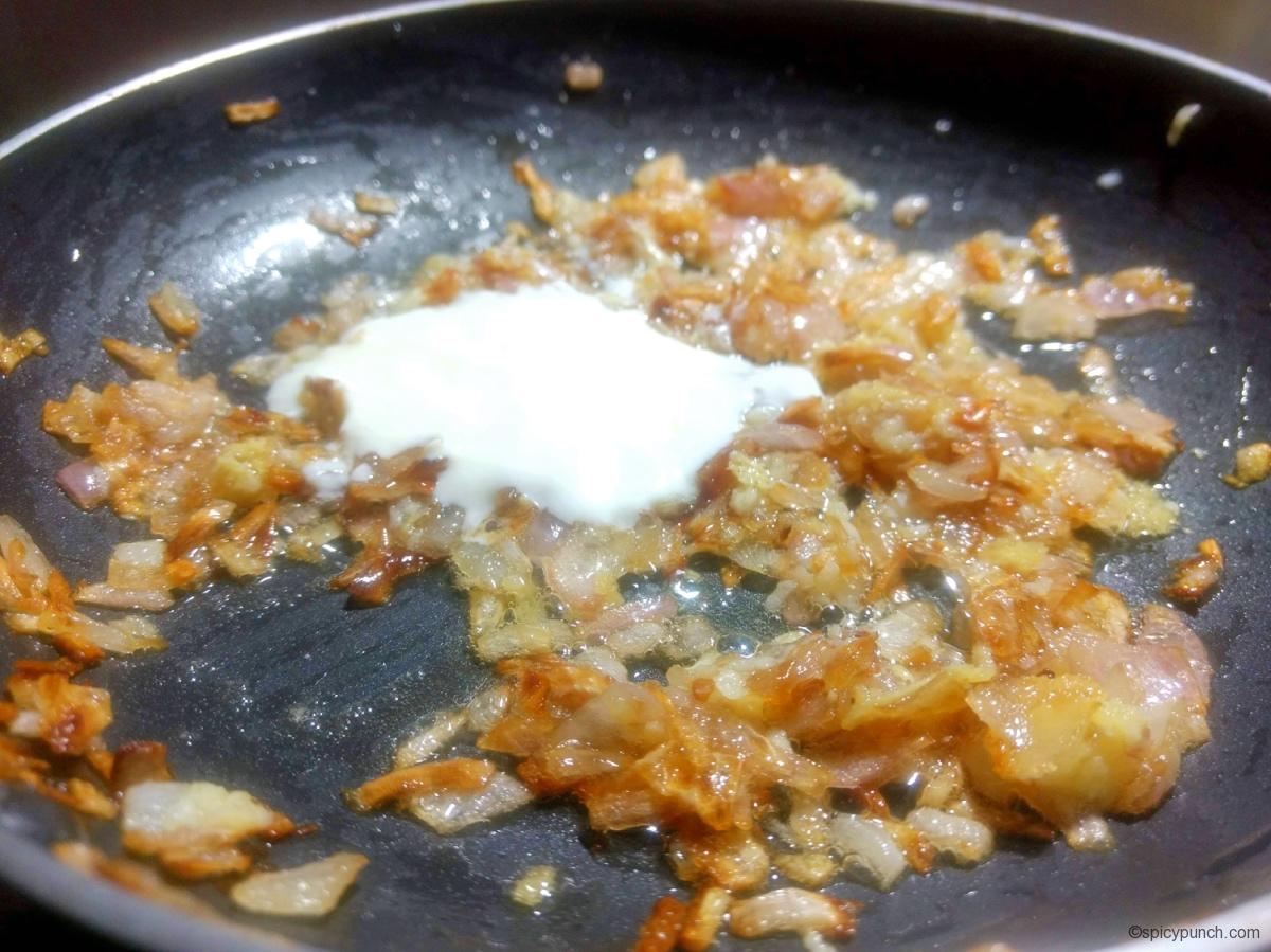 add well beaten curd to the pan for making the gravy of prawn ghee roast