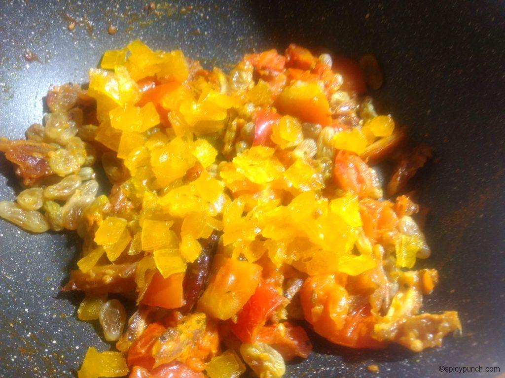 add the aamsotto(cut into cubes) in the pan for making tomato khejur chutney with aamsotto and kismis