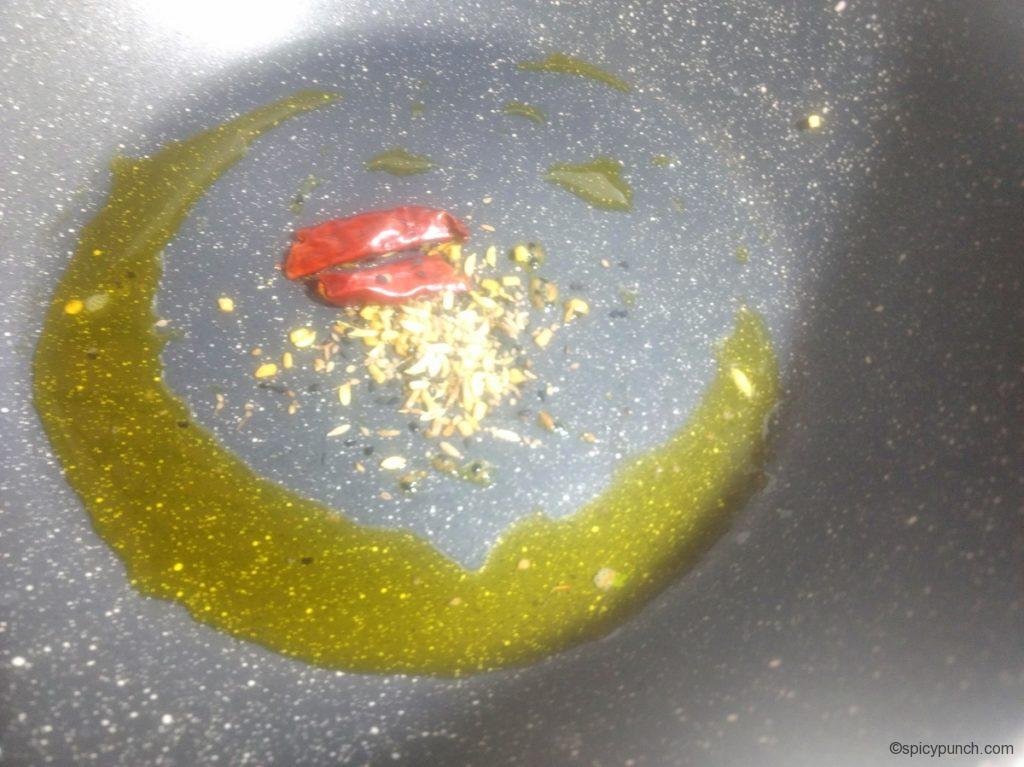 dry red chilli and bengali five spice in the hot mustard oil