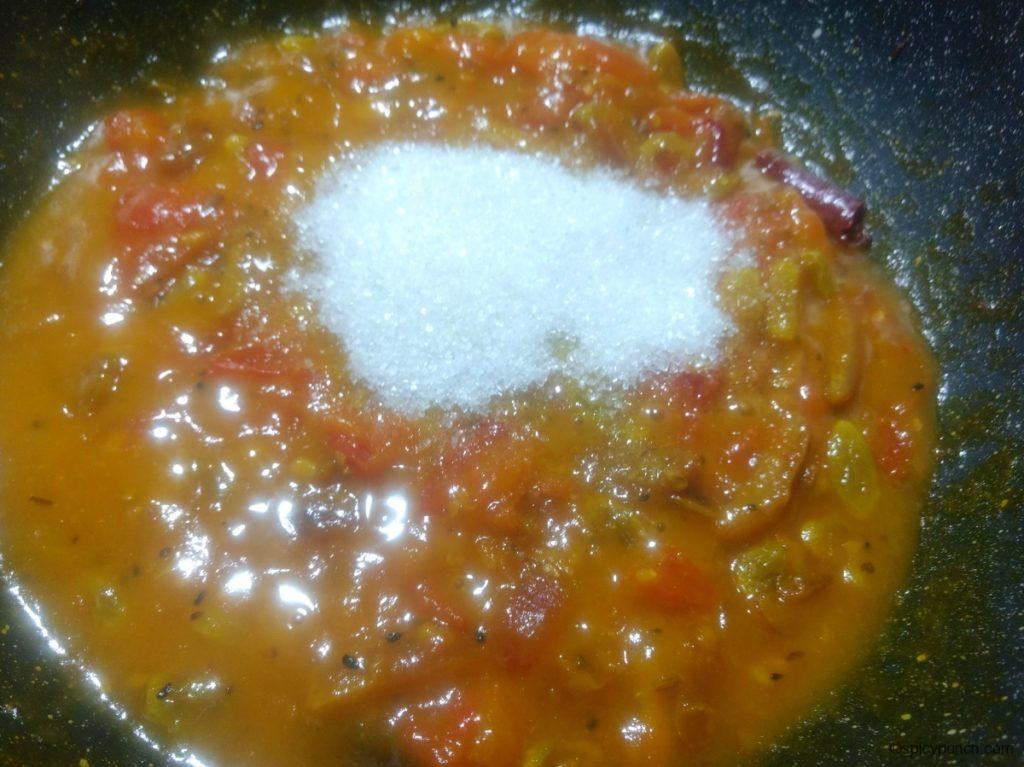 remove the lid of the pan and add sugar to this tomato and date chutney