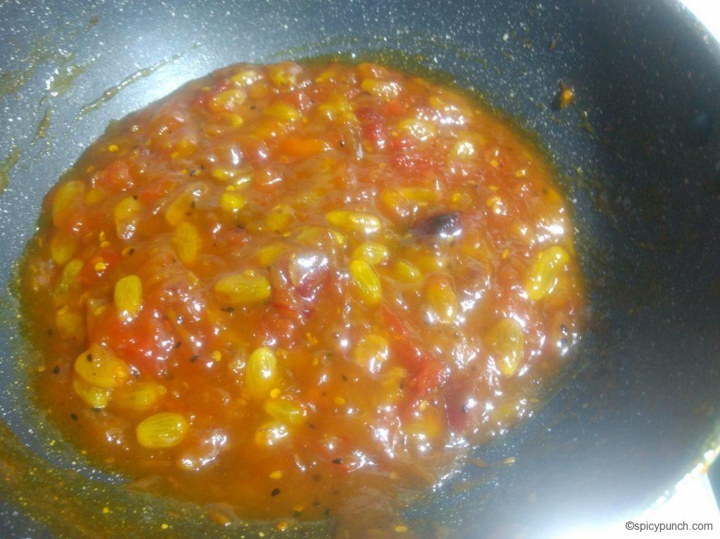 sugar melts down in this bengali tomato khuejur chutney with aamsotto and kismis