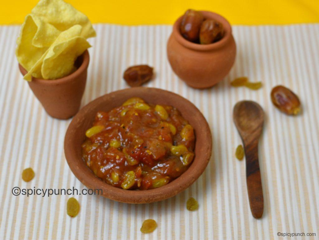 tomato khejur chutney or tomato and date chutney is served with papad