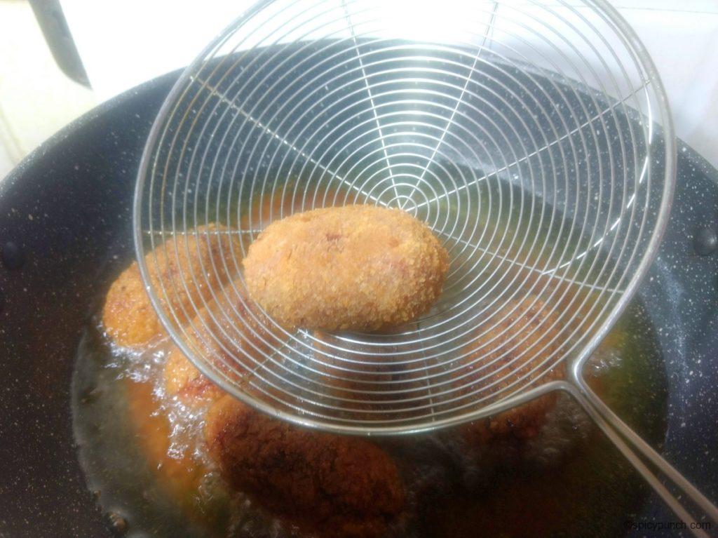 removing the vegetable chop or beetroot cutlet from the pan to plce it on the paper towel for soaking excess oil and make ready vegetable chops recipe