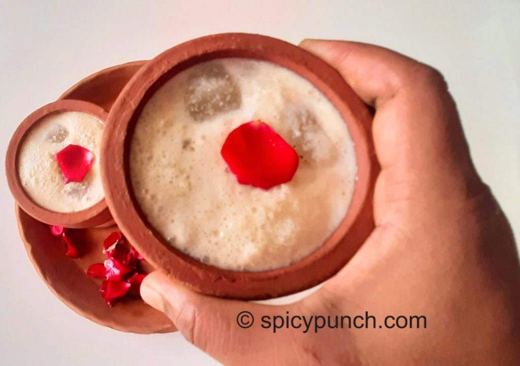 Refreshing cooling delicious homemade badam drink thandai best choice of Indian in holi served in a earthen glass in this picture